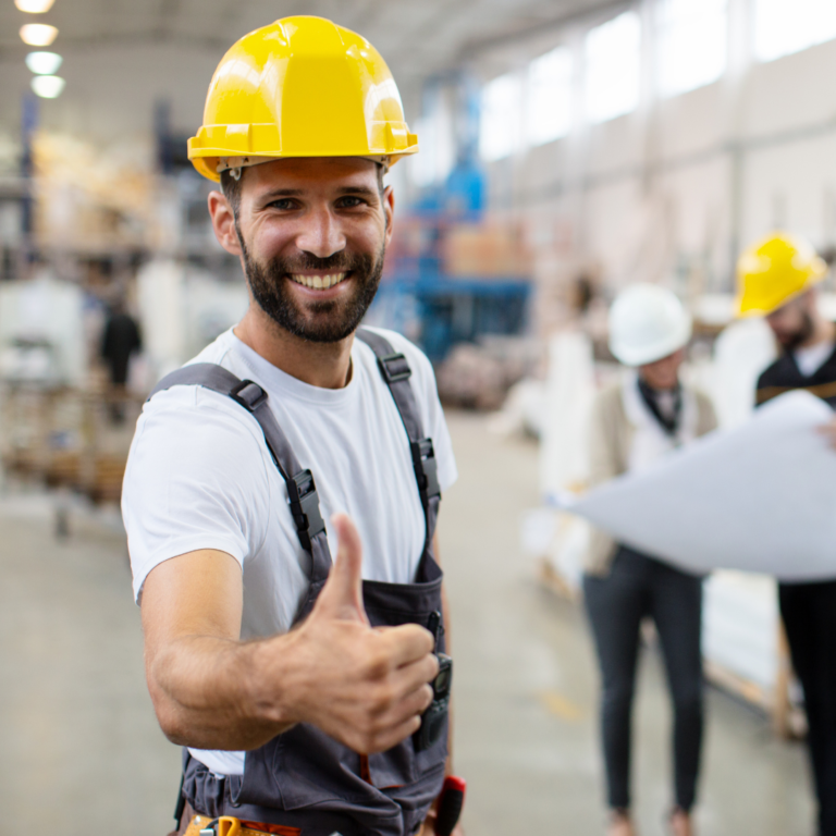 Smiling man in hard hat and work overalls