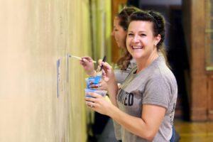 Rockwell employees painting as part of a service project