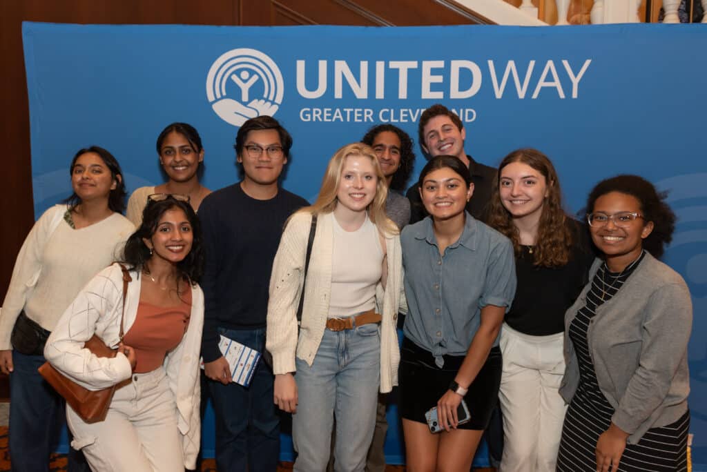 Young professionals in front of united way logo