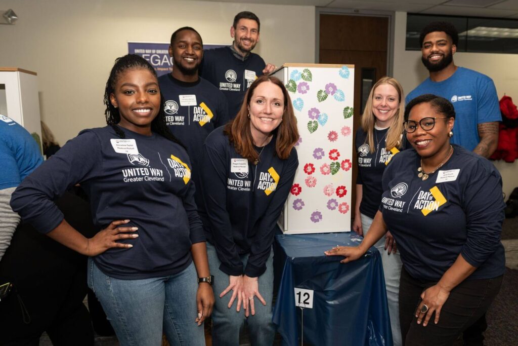 Volunteers smiling around a blessing box
