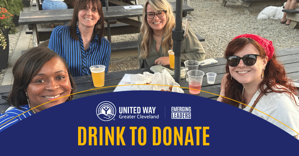 Smiling young professionals at an outdoor table with the heading drink to donate