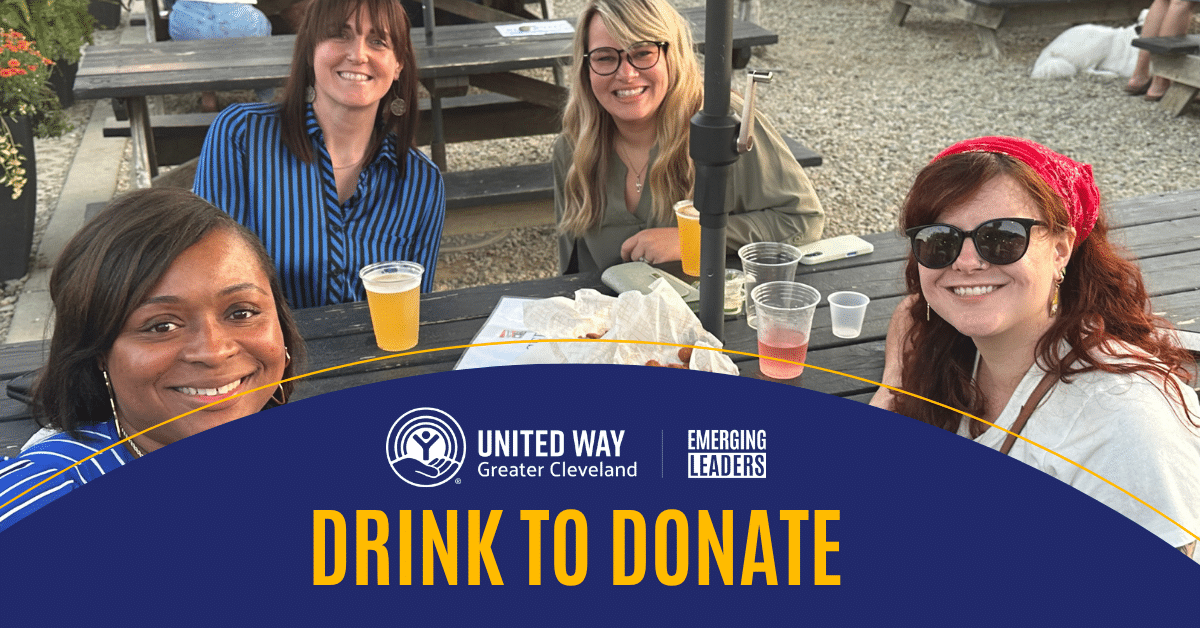 Smiling young professionals at an outdoor table with the heading drink to donate